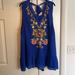 Gauzy type tank top blouse blue with embroidered front and tie detail on back.